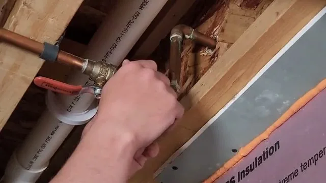 Photo of press connecting copper line in basement ceiling in Tempe, AZ