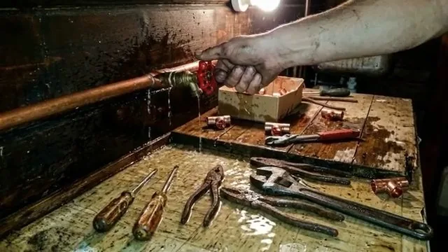Repairing copper pipe in cold workshop on a plumbing job in Tempe